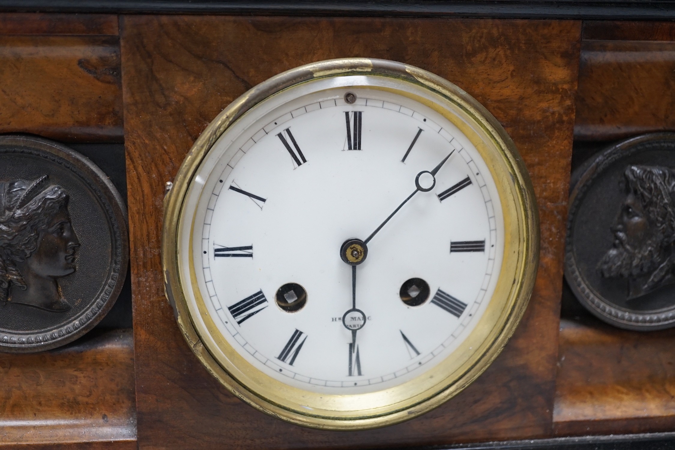 A Victorian walnut and ebonised bracket clock with two classical cartouches, 33cms wide x 23cms high not including bracket